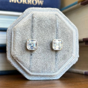 
                  
                    Load image into Gallery viewer, These bezel asscher cut studs are shown in sterling silver.
                  
                