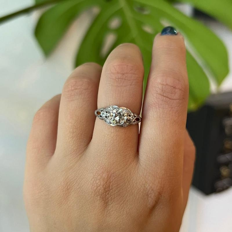 
                  
                    Load image into Gallery viewer, This Edwardian style vintage ring is cast in platinum, has 1 old Euro cut center diamond that is surrounded by 6 single cut side diamonds. The detailed engraving going down the band is the perfect compliment to the vintage cut stones.
                  
                