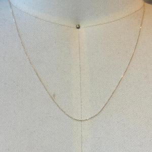 
                  
                    Load image into Gallery viewer, This beautiful and dainty 14 kt solid yellow gold chain is shown on an off white cream bust.
                  
                