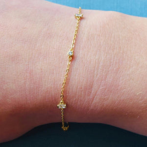 
                  
                    Load image into Gallery viewer, Yellow gold chain bracelet with crystals shown on model&amp;#39;s right wrist.
                  
                