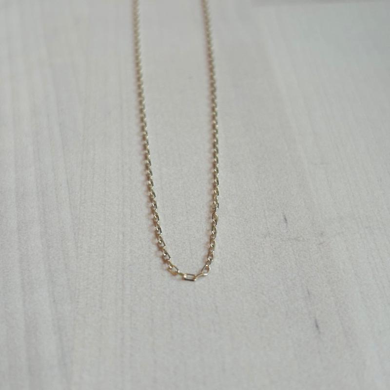 
                  
                    Load image into Gallery viewer, This 14 kt solid yellow gold chain is shown on wooden background.
                  
                