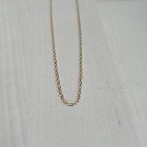 
                  
                    Load image into Gallery viewer, This 14 kt solid yellow gold chain is shown on wooden background.
                  
                