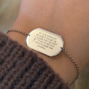 
                  
                    Load image into Gallery viewer, Sterling silver engraved dog tag bracelet shown on left wrist.
                  
                