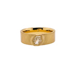 A hexagon cut diamond is bezel set into a 14kt yellow gold band.