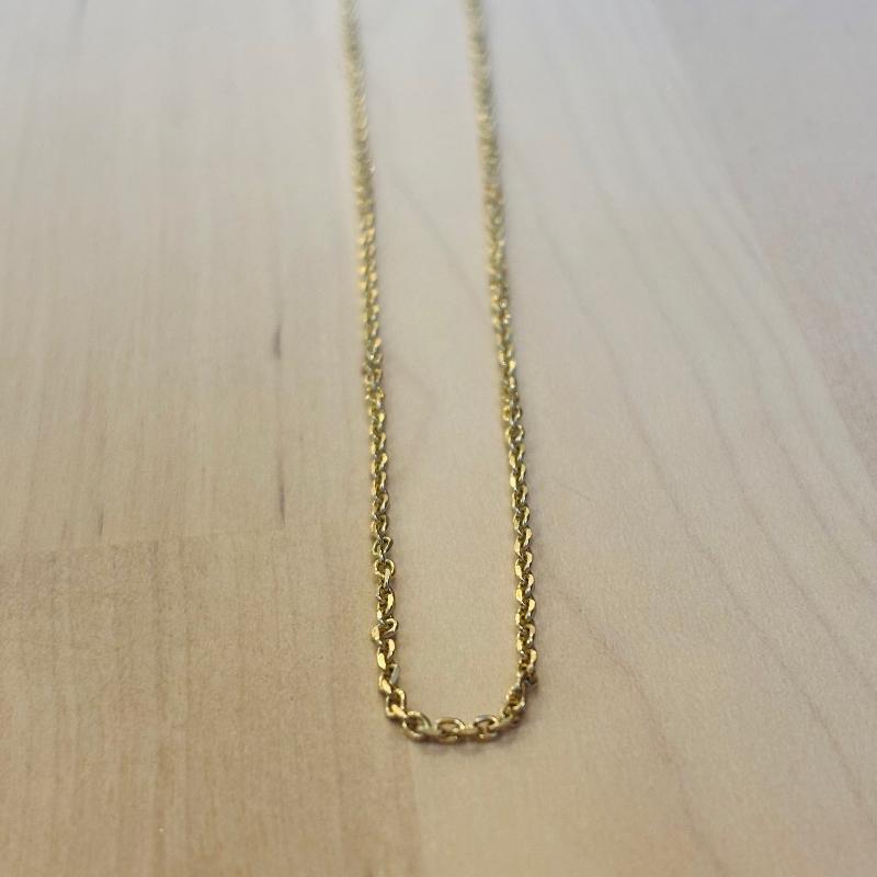 
                  
                    Load image into Gallery viewer, This 14 kt solid yellow gold chain on a wooden background
                  
                