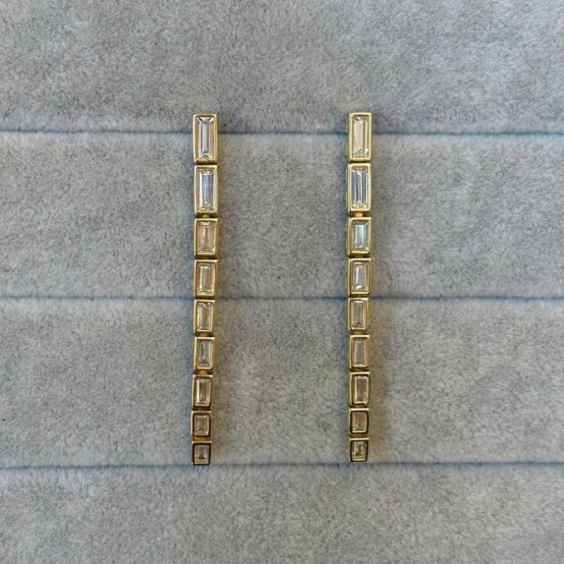 14kt gold vermeil earrings with a 52.5mm drop each contain 9 baguette crystals shown on a gray backround