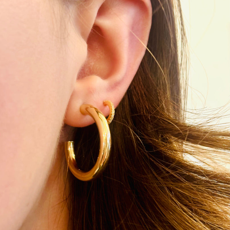 
                  
                    Load image into Gallery viewer, These 14kt yellow gold hoops are timeless treasures, glowing with a warm golden hue that catches the light like sunlight on a serene morning. With a hollow design, these beautiful big hoops are a very comfortable wear, great for all day, everyday.
                  
                