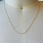 This 14 kt solid yellow gold chain is shown on an off white bust.