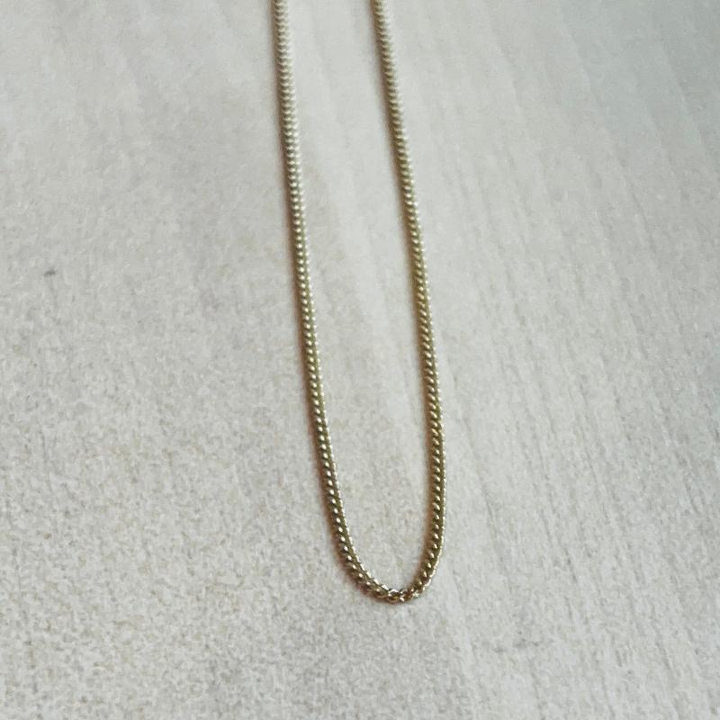 
                  
                    Load image into Gallery viewer, This 14 kt solid yellow gold chain is shown on wooden background.
                  
                