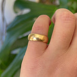 18kt gold band modeled on left pinky finger.