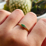 Our petite pear cut emerald and diamond ring is set in a 14 kt gold setting.