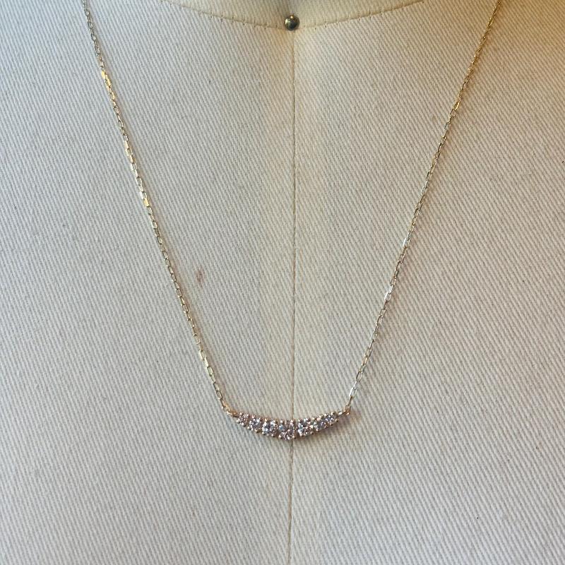 This 7 diamond half moon necklace is set in 14kt yellow gold.