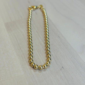 
                  
                    Load image into Gallery viewer, Light and versatile, this bracelet feels so good on your wrist. Made of solid 14 kt gold, a great everyday option for those looking for something both modern, yet timeless. Available in a small and medium.
                  
                