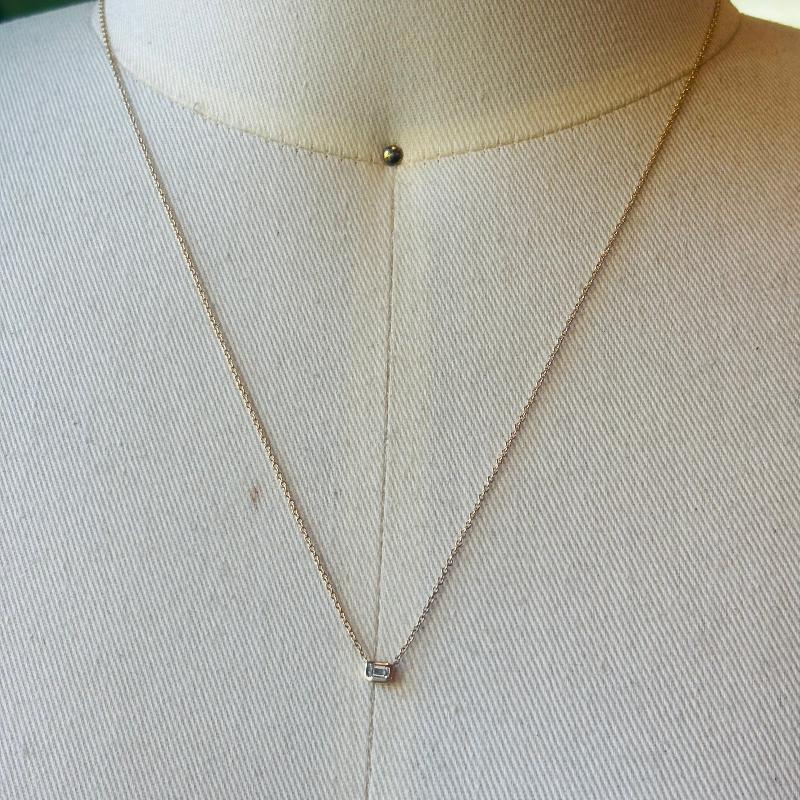 This necklace is perfect for an everyday, simple but beautiful look. A Emerald cut bezel diamond set in solid 14kt yellow gold