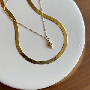 
                  
                    Load image into Gallery viewer, The younger sibling to our North Star pendant necklace, our North Star charm necklace is made of solid 14 kt gold.
                  
                