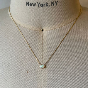 
                  
                    Load image into Gallery viewer, Oval opal necklace casted in 14kt yellow gold shown on bust for scale.
                  
                