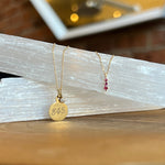 With 3 round cut rubies set in solid 14 kt yellow gold, we love the simplicity and beauty of this pendant necklace.