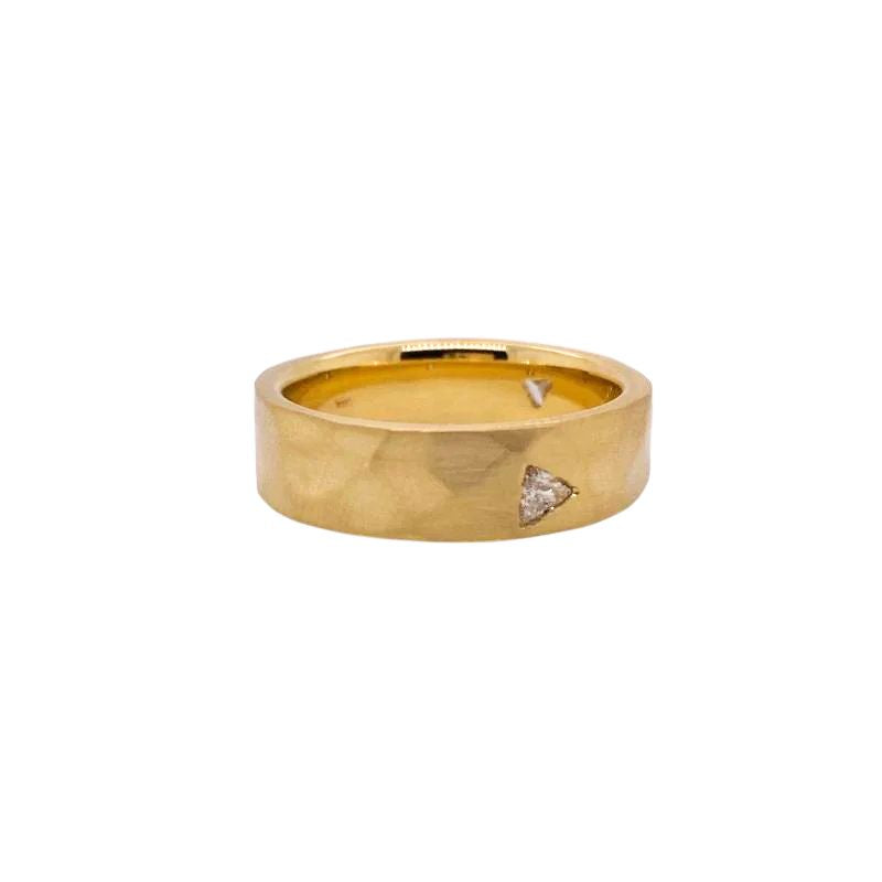 With a matte, hammered finish in 14 kt gold, this band has three flush set trillion cut diamonds flush set into it. A unique piece to add to any stack or serve as a statement on its own.