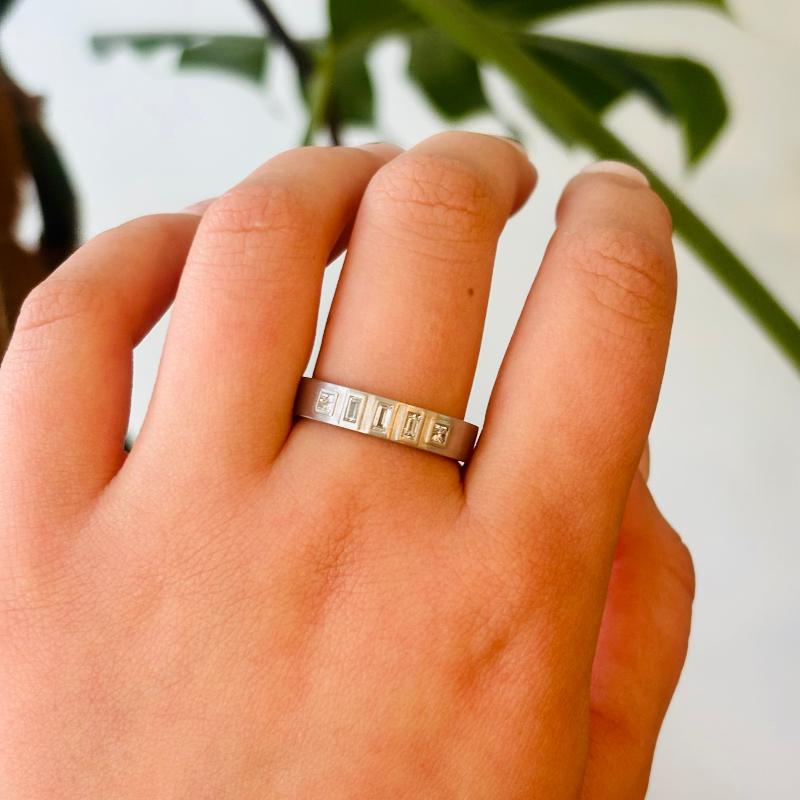 
                  
                    Load image into Gallery viewer, We love the modern feel the princess and baguette cut diamonds&amp;nbsp;give to this platinum matte finish classic squared edge band. With a center baguette cut diamond set between a pair of baguette and princess cut diamonds, this ring is perfect for everyday wear.
                  
                