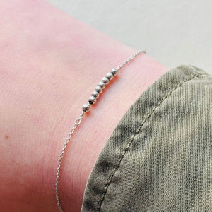 
                  
                    Load image into Gallery viewer, Sterling silver beaded bracelet on model&amp;#39;s right wrist.
                  
                