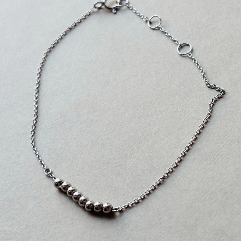 
                  
                    Load image into Gallery viewer, Sterling silver bracelet styled on a white book.
                  
                