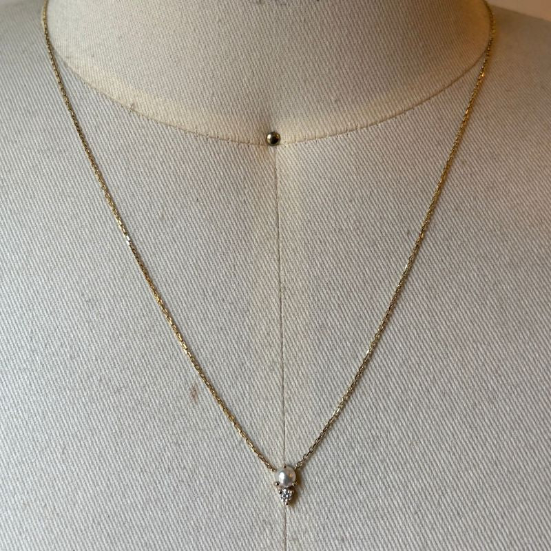 
                  
                    Load image into Gallery viewer, Seraphine pearl and diamond necklace shown in 14kt yellow gold on bust for scale.
                  
                