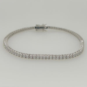 
                  
                    Load image into Gallery viewer, This crystal tennis bracelet is available in sterling silver and secured with a box-clasp closure. An affordable and stylish option for all occasions.
                  
                