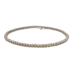 
                  
                    Load image into Gallery viewer, A classic diamond tennis bracelet cast in 14 kt white gold with a box clasp on a white background.
                  
                