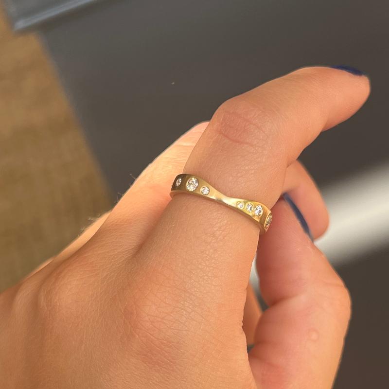 
                  
                    Load image into Gallery viewer,  This 14 kt gold shadow band is adorned with 23 round cut white diamonds. The unique curvature of this ring allows it to rest perfectly against several of our gemstone rings. A beautiful complement to an engagement ring, yet looks amazing when worn by itself as well.
                  
                