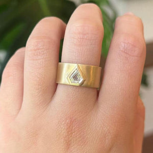 
                  
                    Load image into Gallery viewer, With a satin matte finish, this kite cut diamond is bezel set into a 14kt yellow gold band that tapers in the back for maximum comfort. A truly stunning piece.
                  
                