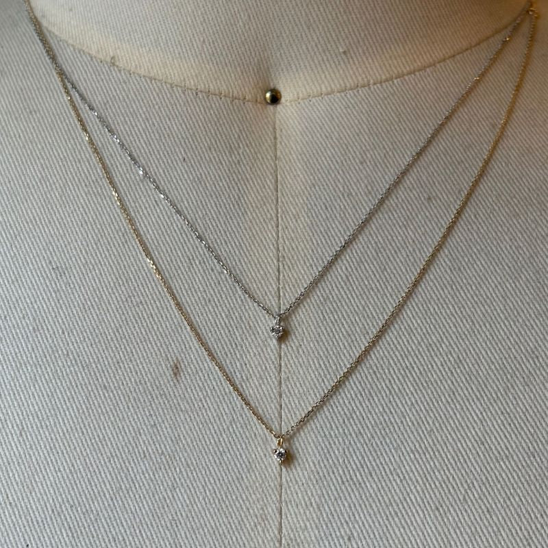 2 petite diamond necklaces shown in 14kt yellow and white gold on bust for scale.