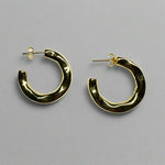 3/4 organic style hoop earrings with posts made of 14 kt yellow gold vermeil on an ivory colored tile.