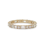 Front view of a diamond eternity band with round, asscher and baguette cut diamonds cast in 14 kt yellow gold.